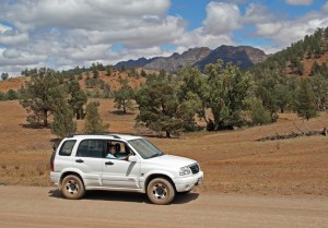 b Driving along the trail with the Elder Ranges in the background