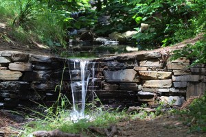 The brook cascades over a small ford made from slate and sandstone rocks